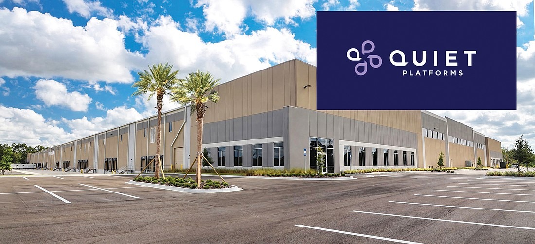 A Quiet Platforms fulfillment warehouse exterior with the Quiet Platforms logo